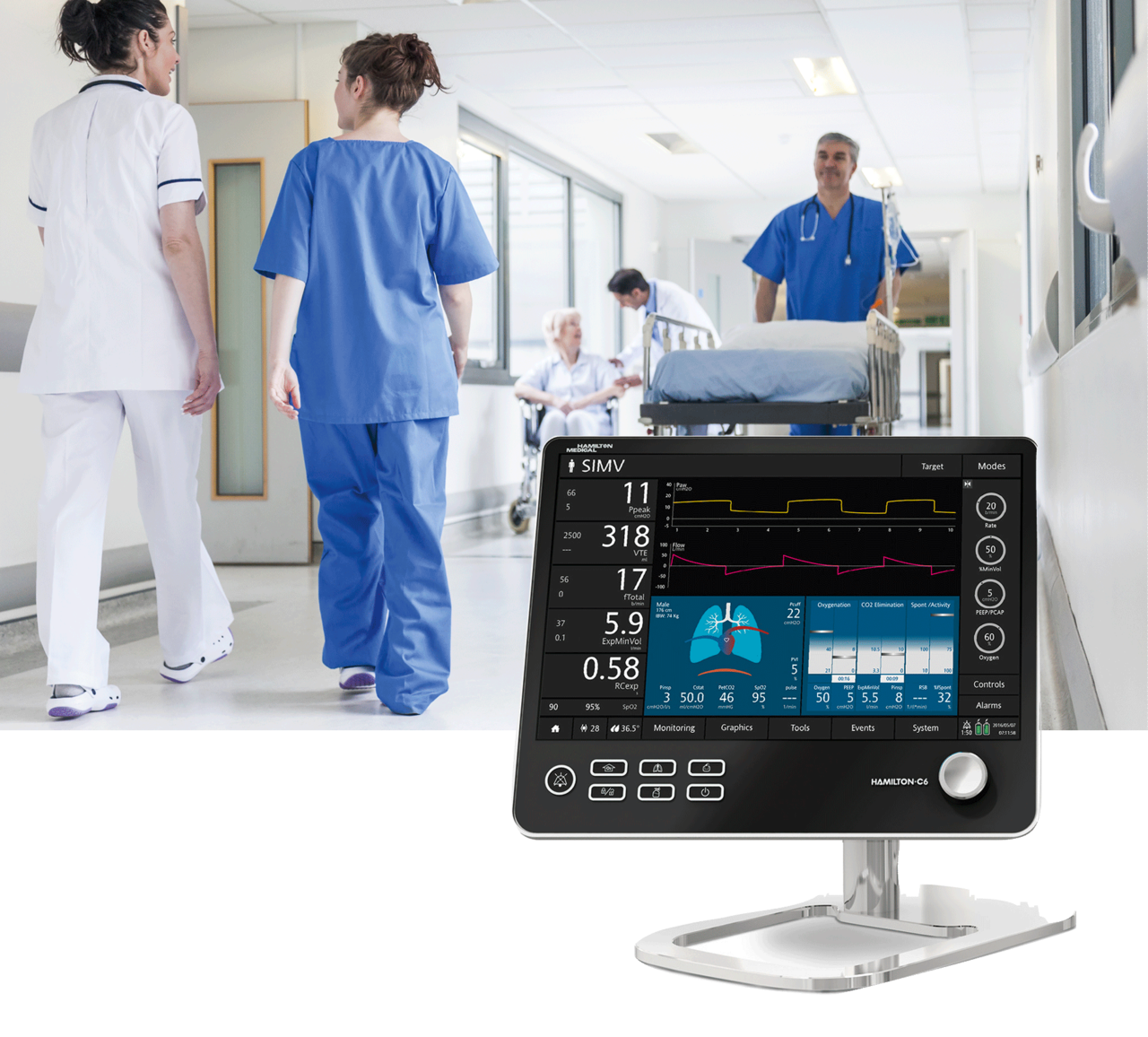 People in the corridor of a hospital in front of it the control panel of a ventilator